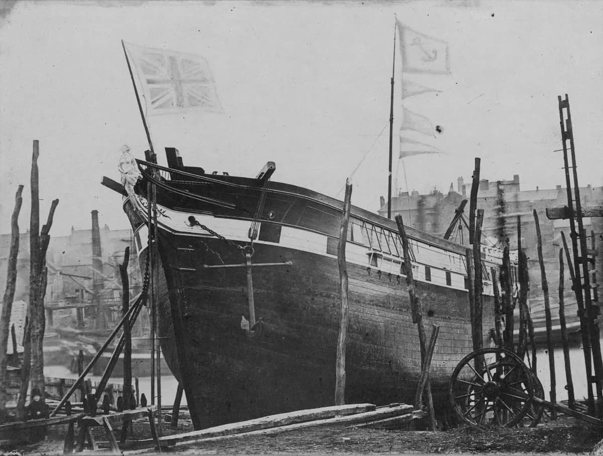 The wooden barque Vencedora on the stocks at North Sands, propped with timbers and flying flags, ready to slide into the Wear.
